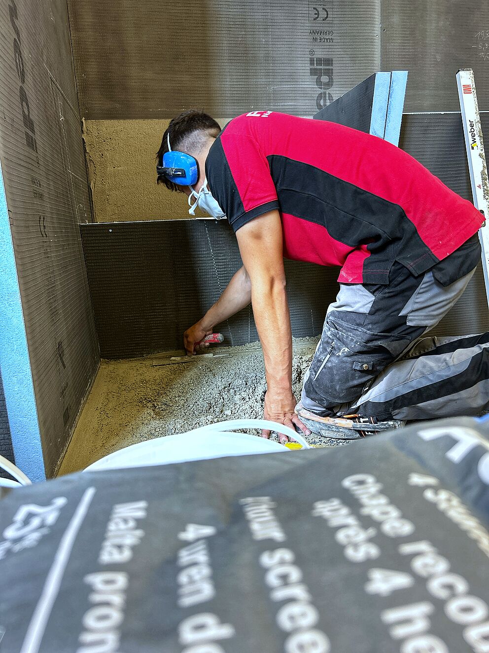 Luca Kühne bei der Estrichverlegung